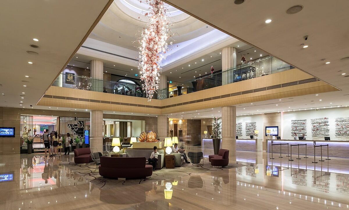 Hotel reception desks in Singapore where a guest checks in with a B2B hotel confirmation number