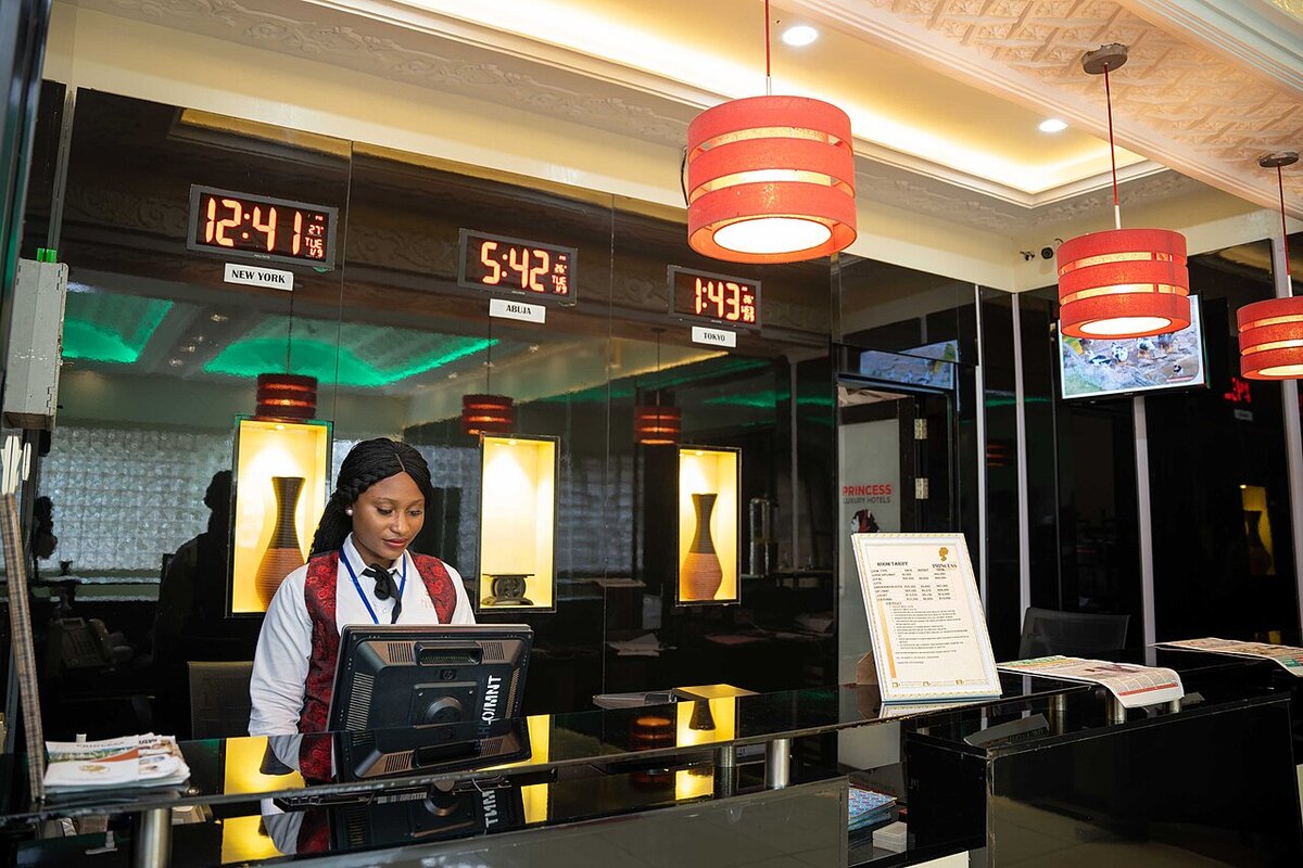 Hotel front desk agent at a reservation terminal, where wholesale bookings from bedbanks arrive