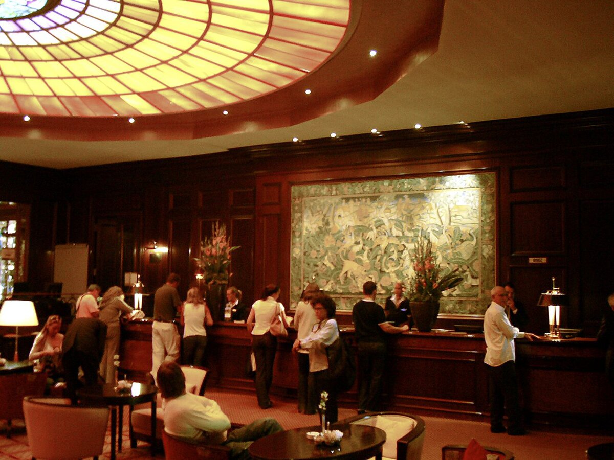 Guests at a hotel front desk, where package rate prices must stay undisclosed