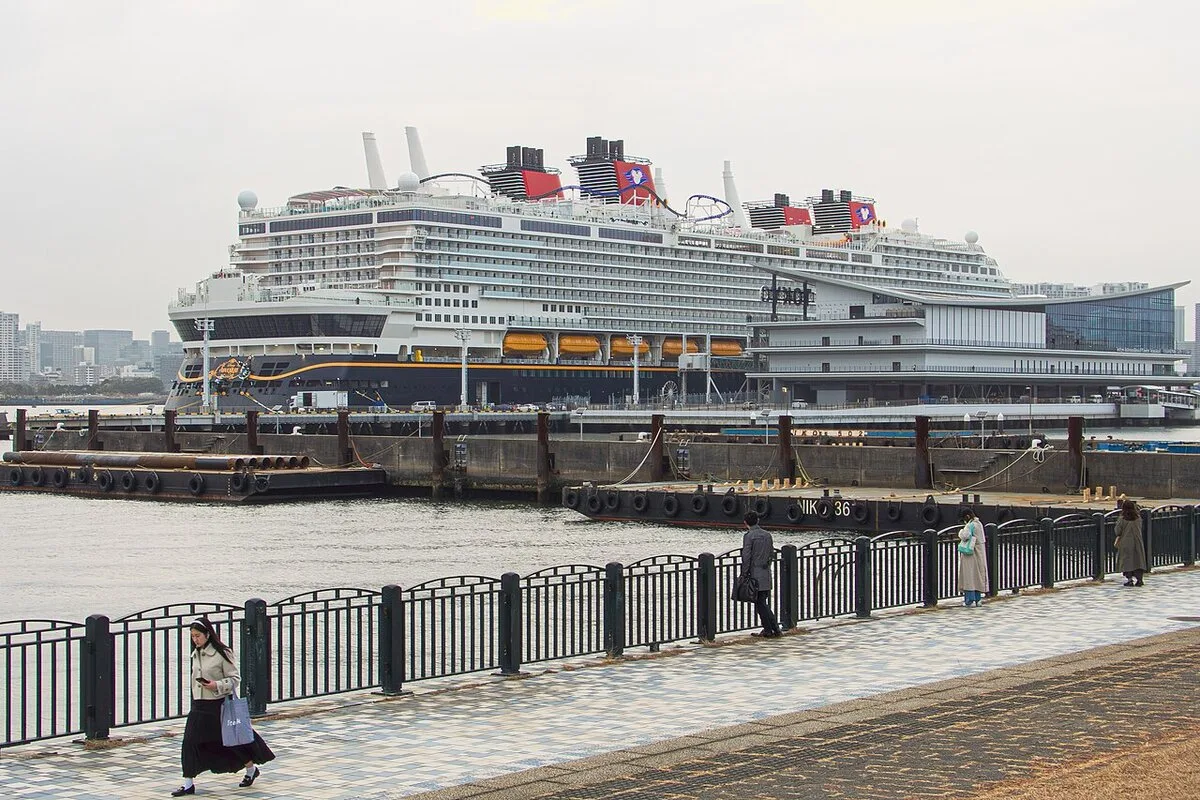 Disney Adventure cruise ship docked at a cruise terminal before arriving in Singapore