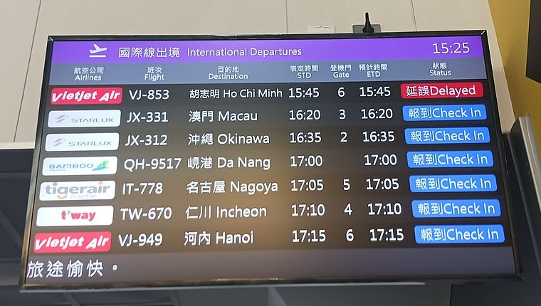 Airport departures screen listing flights to Okinawa, Da Nang and Incheon